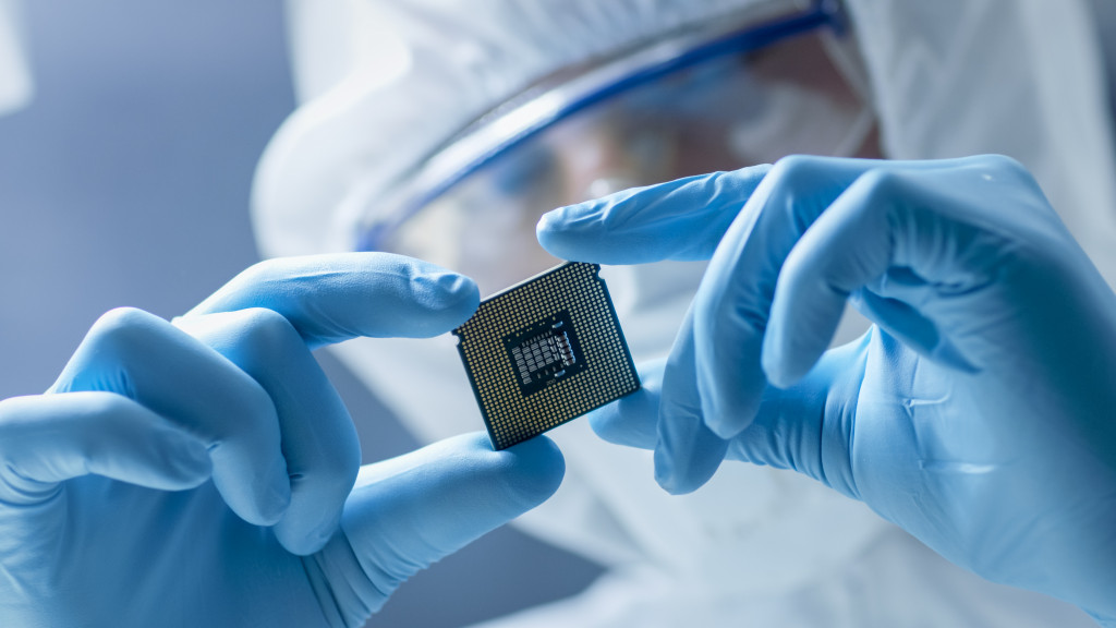 worker holding a microchip for nanotech