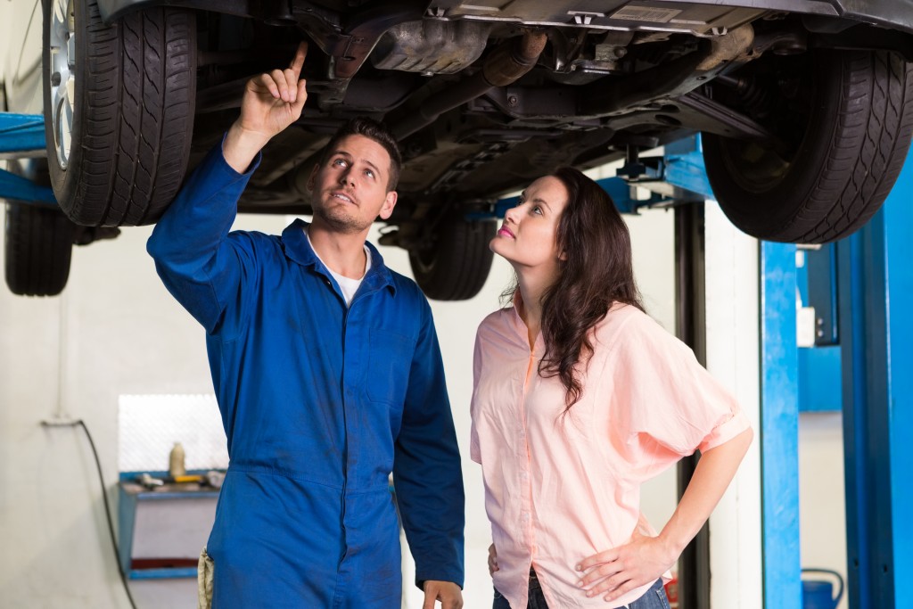 mechanic showing customer her car issues