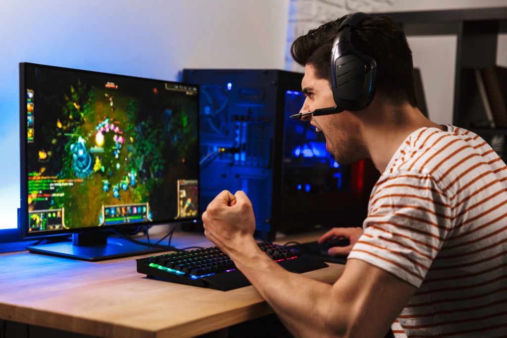 A gamer wearing wireless headsets while playing