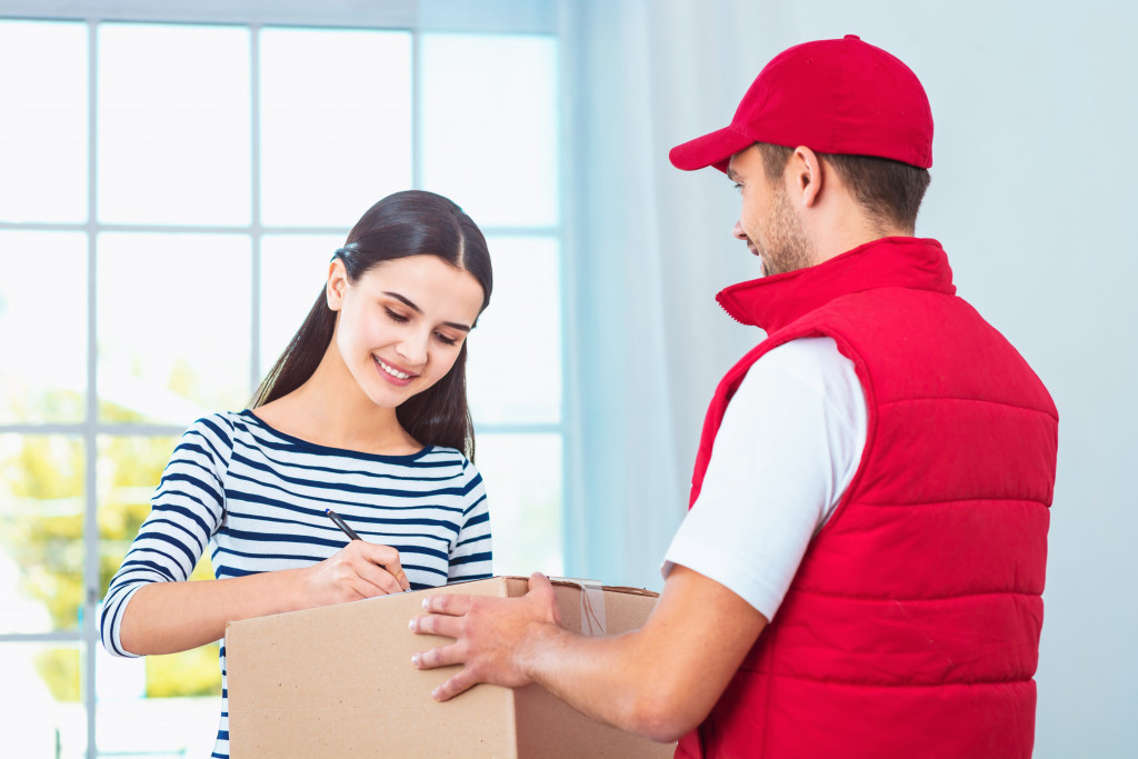 man delivering the parcel to a woman