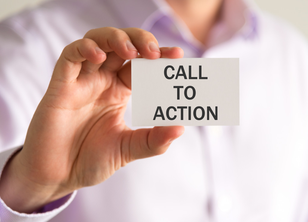 person holding card with call to action on it